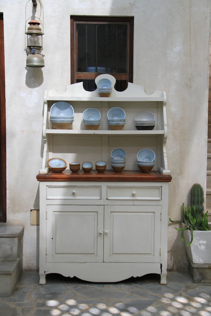 Vintage Kitchen Cabinet with Bowls and Plates Placed in It